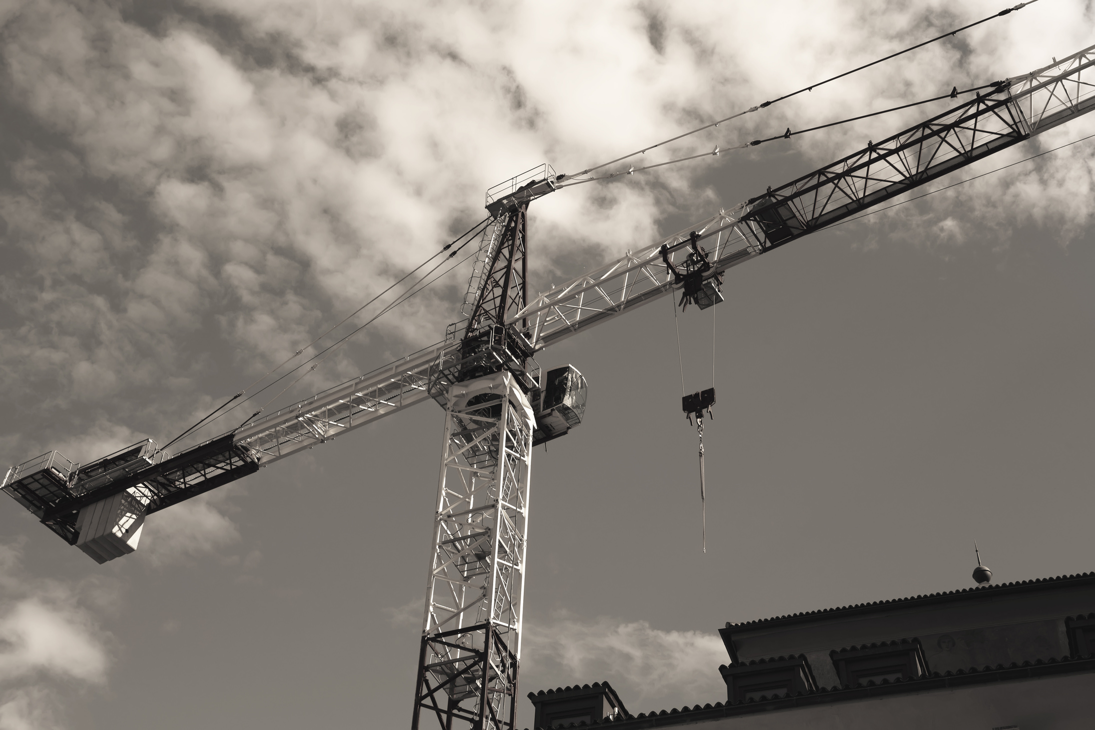 the construction crane over blue sky background .Construction crane tower against a blue sky